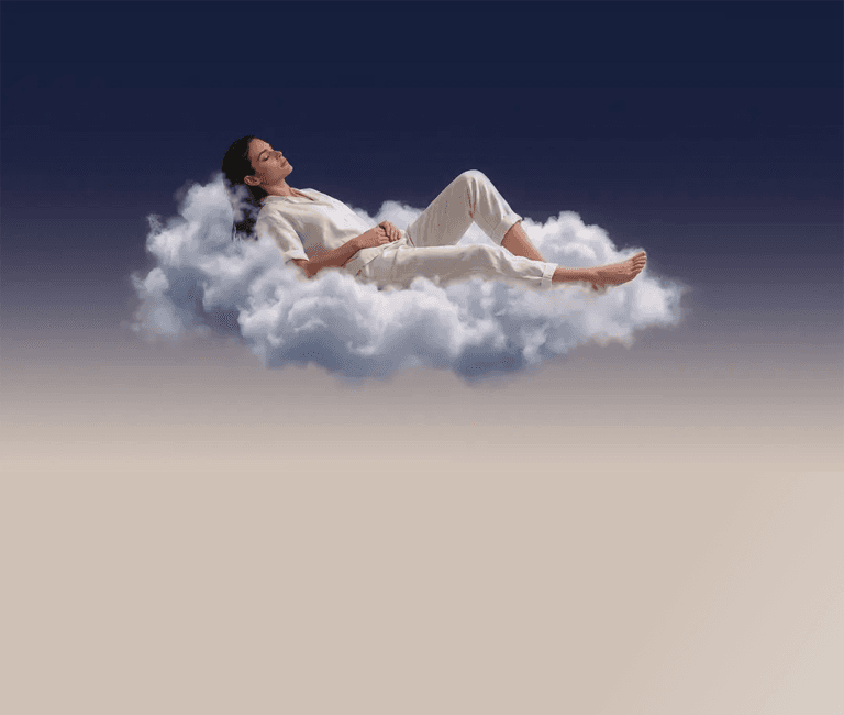 A woman resting on a cloud as night turns to dawn